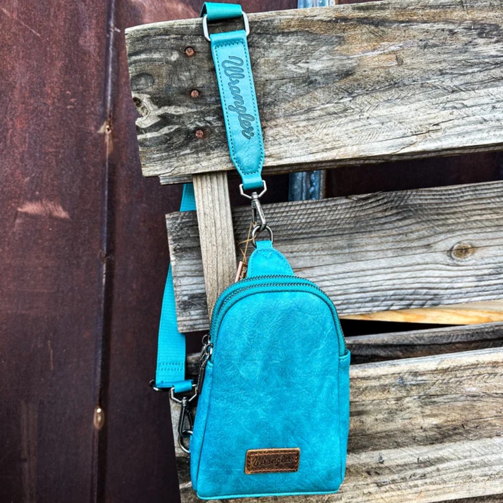 Brand new, unopened wrangler sling purse- teal
